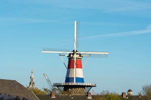 Explore the historic Molen de Valk windmill in vibrant Leiden, Netherlands on a clear, sunny day.